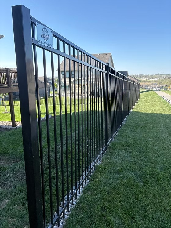 Black iron fence extended property run by fence contractor Bellevue, NE