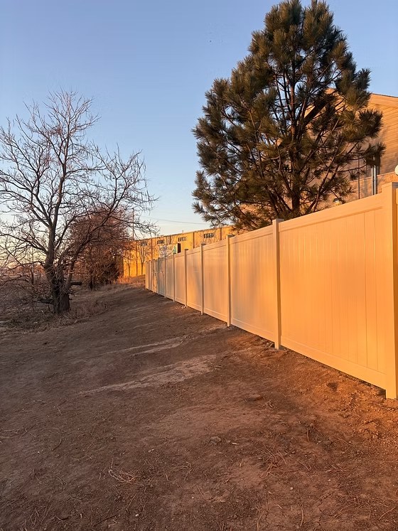 Tan commercial vinyl privacy fence installation serving Bellevue and Sarpy County