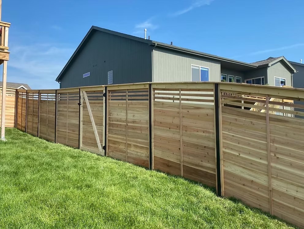 Modern horizontal wood privacy fence with black posts by fence contractor Bellevue, NE Taylormade Fence LLC