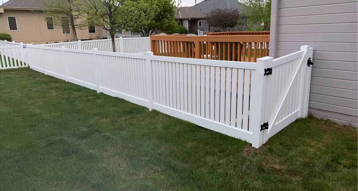 White vinyl fence with gate and black hardware installed in Bellevue, NE